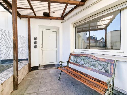 a bench sitting on a porch with a window at Tolstov Apartments - 1 or 3 Room Apartments with Balcony - 20 Min Messe DUS & Airport DUS in Meerbusch