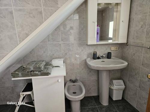 a bathroom with a sink and a toilet at Casa Lina VUT OR 000784 in Allariz