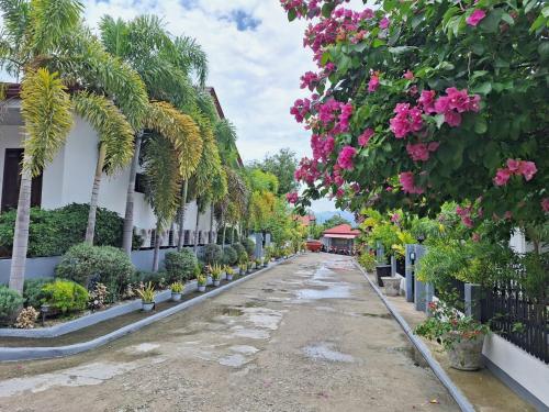 a street lined with flowers and plants at Garden Village Resort in Moalboal