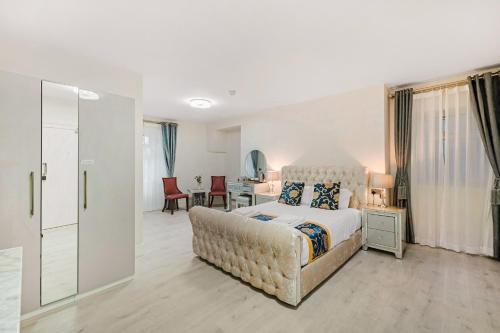 a bedroom with a king sized bed and a couch at Drake Hotel Plymouth in Plymouth