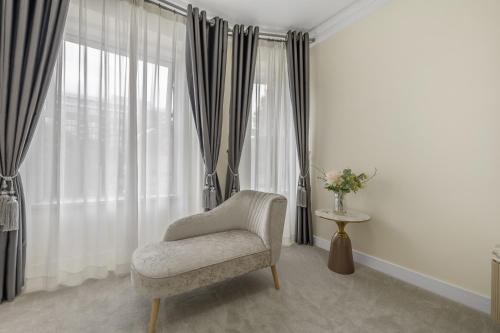 a living room with a chair and a window at Drake Hotel Plymouth in Plymouth