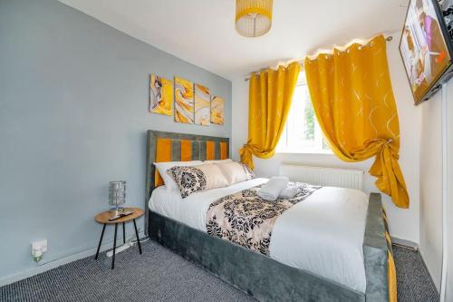 een slaapkamer met een bed en een raam met gele gordijnen bij *F6GH For your most relaxed & cosy stay + FREE PARKING & WiFi in Bramley