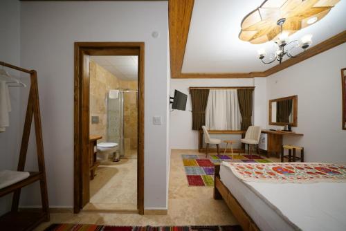 a bedroom with a bed and a bathroom at Pashahan Hotel in Göreme