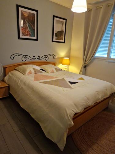 a bedroom with a large bed with a white comforter at Maison meublée de la Varenne in Pannes