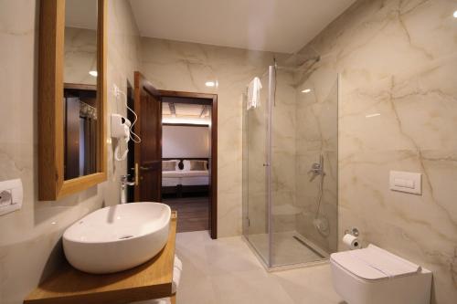 a bathroom with a toilet sink and a shower at Kruja Albergo Diffuso , Inside Kruja Castle in Krujë