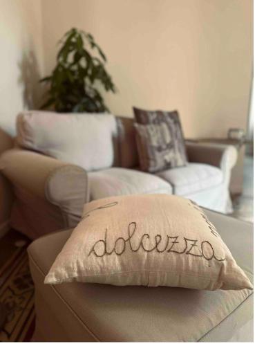 a living room with a couch and a pillow at Hotel Ristorante San Giuseppe in Cernobbio