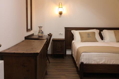 a room with two beds and a desk and a bed sidx sidx sidx at Kruja Albergo Diffuso , Inside Kruja Castle in Krujë