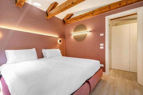 a bedroom with a large white bed in a room at Ca' San Carlo Residence by Wonderful Italy in Venice