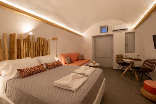 a bedroom with a bed and a living room at CABO ESTE SUITES in Akrotiri