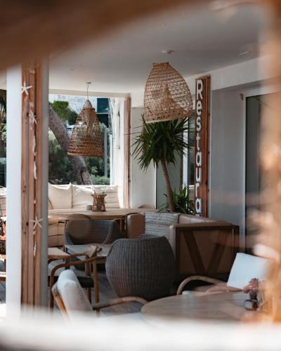 a living room with chairs and a table at Hotel de La Plage - Mahogany in Cassis