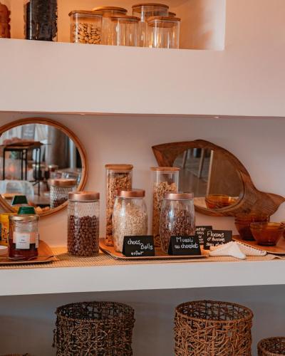 a shelf with jars of food and mirrors at Hotel de La Plage - Mahogany in Cassis
