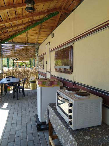 an old train car sitting on a patio at camping hydraswave bungalow caravan in Thermisia
