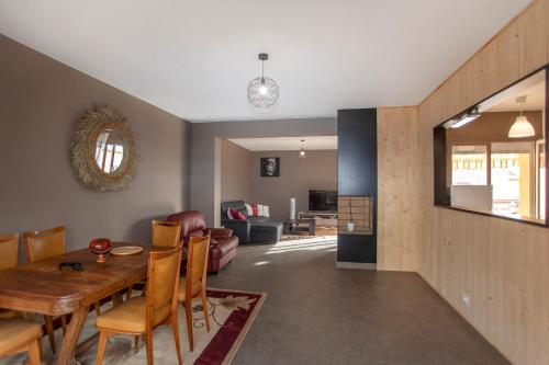a dining room and living room with a table and chairs at BLUE HOME in Roanne