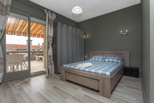 1 dormitorio con 1 cama y balcón en BLUE HOME, en Roanne
