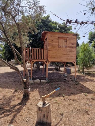 a wooden tree house with a stick in front of it at Private Villa in Naxxar