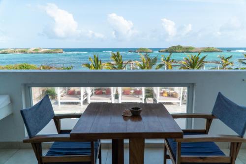 a table and chairs with a view of the ocean at Visiwa Beach Resort in Watamu