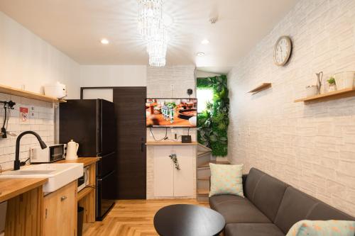 a kitchen and living room with a couch and a sink at 池袋C1出口徒歩5分　2LDK まるまる貸切　衛生設備充実 in Tokyo