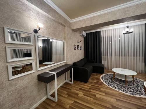 a living room with a couch and a table at Park Azure 0568 in Baku
