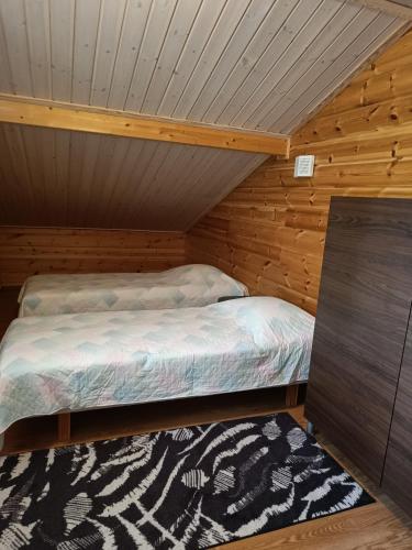 a bedroom with a bed in a wooden cabin at VILLA OLGA in Tahkovuori