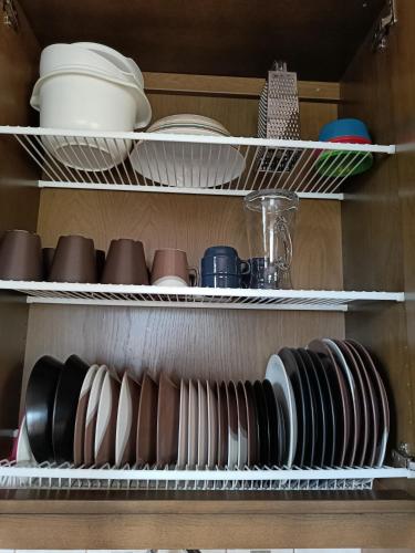 a shelf filled with plates and bowls and dishes at VILLA OLGA in Tahkovuori