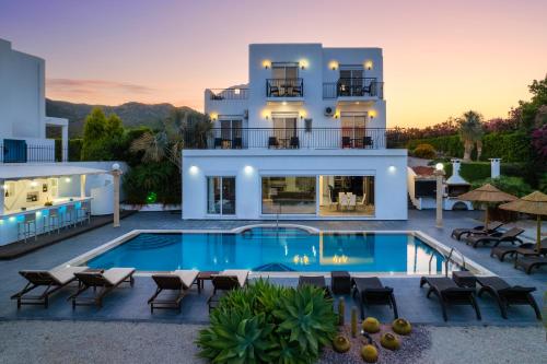 a villa with a swimming pool in front of a house at Diamond Villa in Gennadi