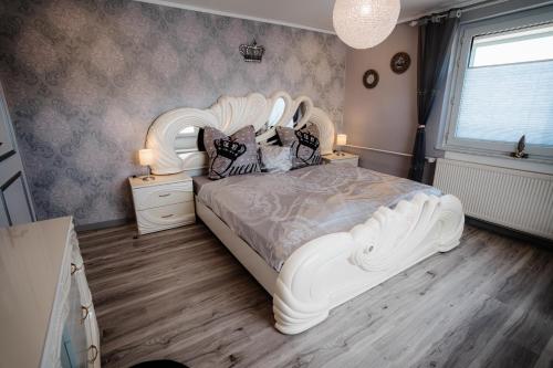 a bedroom with a white bed with pillows on it at Timeout Royal in Ellar