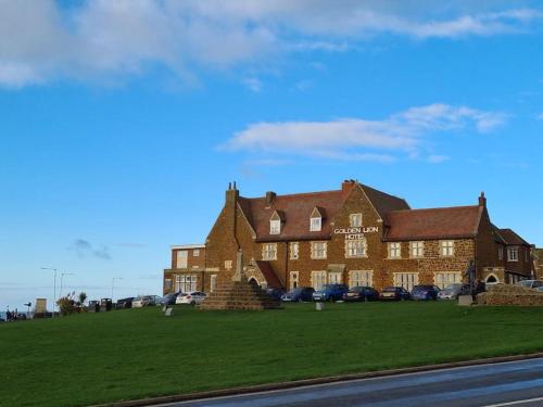 a large brick building with cars parked in front of it at Modern 6 Berth Static Caravan, Hunstanton in Hunstanton