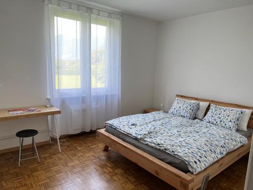 a bedroom with a bed and a window and a desk at Casa Romana in Gambarogno