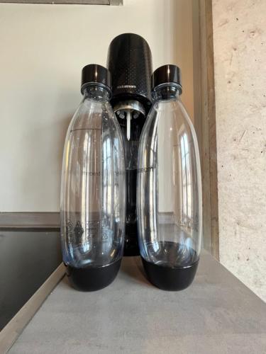 two glass bottles sitting on top of a counter at Ancien Cinema Loft in Vianden