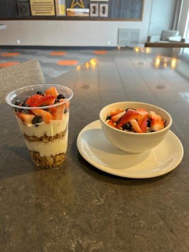 a cup of dessert and a bowl of fruit on a table at Four Points by Sheraton Barrie in Barrie