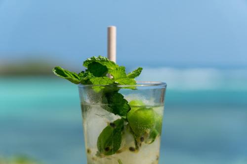 a drink with lime and mint on a blue background at Visiwa Beach Resort in Watamu
