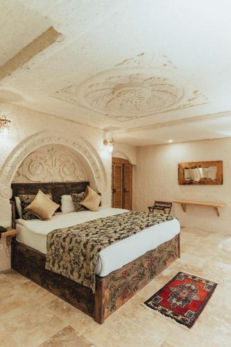 a bedroom with a large bed with a coffered ceiling at Harem Suites Cappadocia in Uchisar