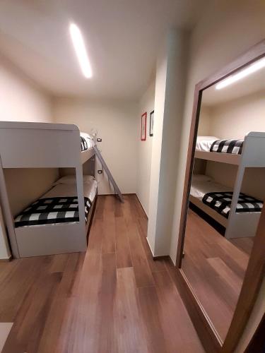 a room with two bunk beds and a mirror at L'alba di Langa in Narzole