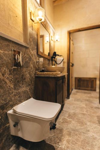 a bathroom with a toilet and a sink at Harem Suites Cappadocia in Uchisar