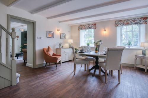 a dining room with a table and chairs at The Stables - 2 Bedroom Cottage - Princes Gate in Ludchurch