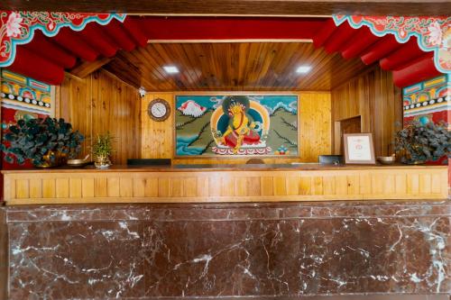 a temple with a painting on the wall at Buddha Retreat in Ravangla