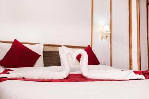a bed with two swans made out of towels at Buddha Retreat in Ravangla