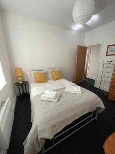 a bedroom with a bed with two towels on it at 2 bedroom apartment in Kidderminster (The place to be) in Kidderminster