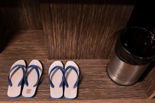 a group of three pairs of shoes and a trashcan at Buddha Retreat in Ravangla