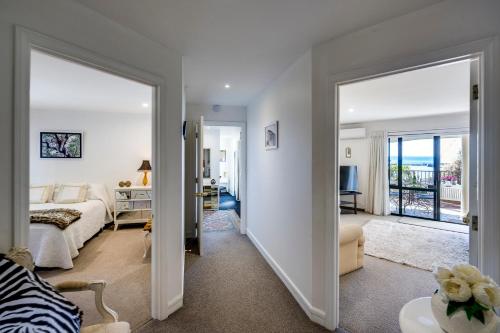 a bedroom with a bed and a living room at Maison Blue - Chic Garden Apartment in Napier