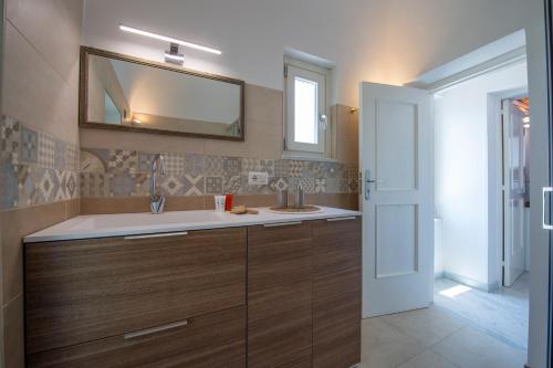 a bathroom with a sink and a mirror at La Casetta di Camilla - Amalfi coast in Minori
