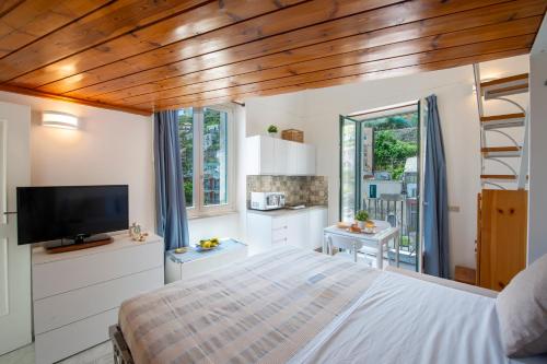 a bedroom with a bed and a tv in a room at La Casetta di Camilla - Amalfi coast in Minori