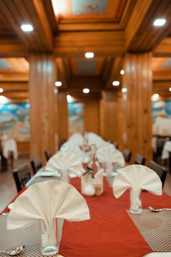 a dining room with a table with white napkins on it at Sikkim Tourist Centre in Pelling