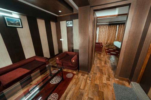 an overhead view of a living room with red furniture at Sikkim Tourist Centre in Pelling