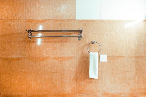 a bathroom with a white towel hanging on a wall at Sikkim Tourist Centre in Pelling