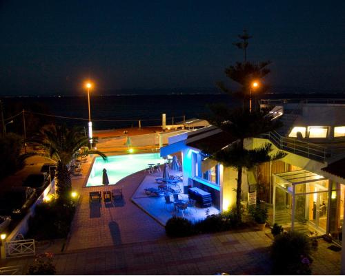 a house with a swimming pool at night at Lasia Hotel in Mytilini