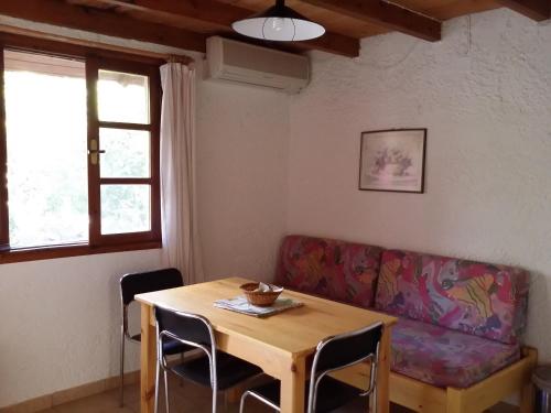 a living room with a table and a couch at 2bedrooms Cottage 1 in Palaiochóra