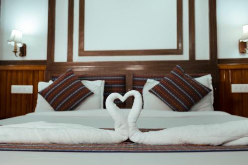 two swans making a heart on a bed at Yangthang Dzimkha Resort in Pelling