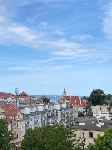 a view of a city with buildings and the ocean at Hacienda in Sopot