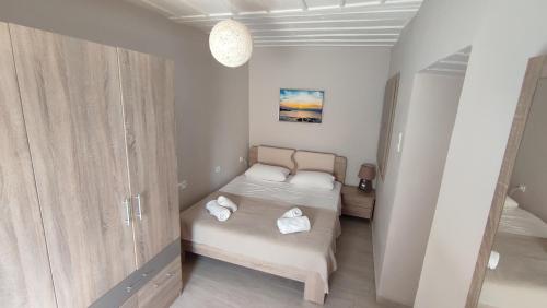 a small bedroom with two beds in a room at Aegean View in Ermoupoli